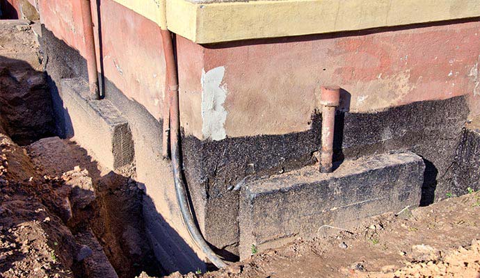 An exterior view of an excavated building foundation wall