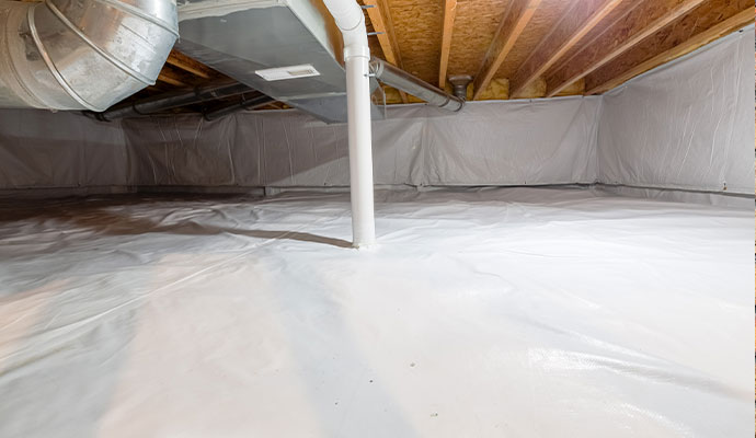 Professional worker sealing crawl space