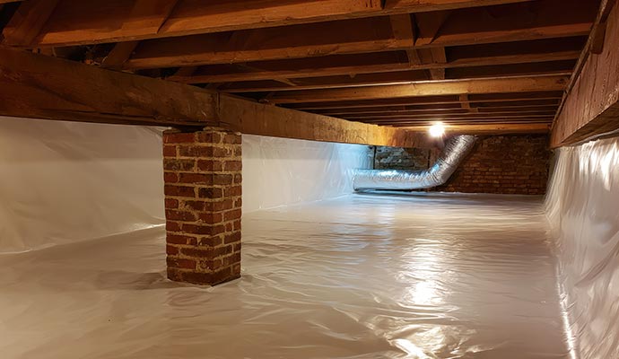 Clean crawl space with installed vapor barrier and brick support