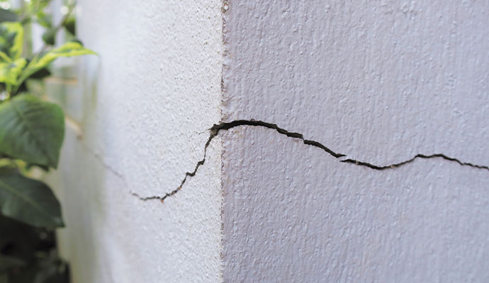 Horizontal structural crack visible on an exterior wall
