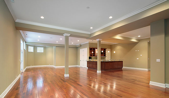 Finished basement with hardwood floors and a wet bar