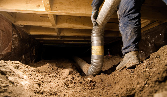 Professional technician repairing crawl space