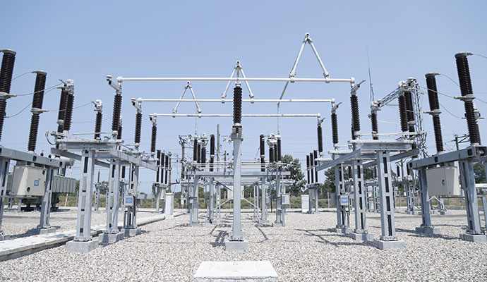 An outdoor high-voltage electrical power substation with transformers and insulators