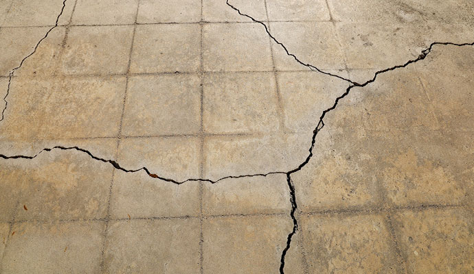 Large branching cracks across a concrete slab floor