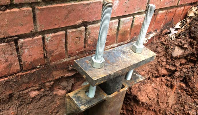 A close-up shot of a heavy-duty steel foundation underpinning pier bracket